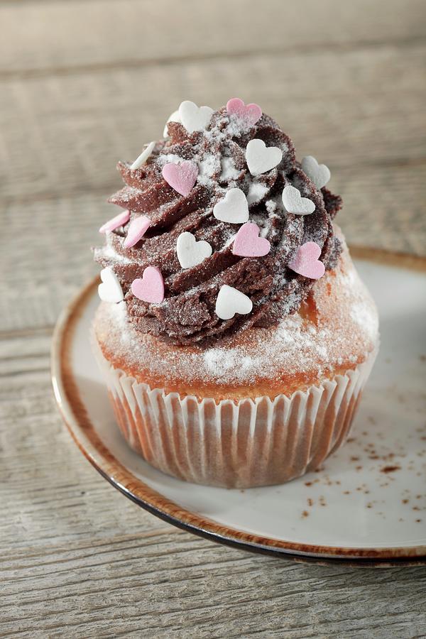 A Cupcake Decorated With Chocolate Buttercream And Sugar Hearts Photograph by Niklas Thiemann