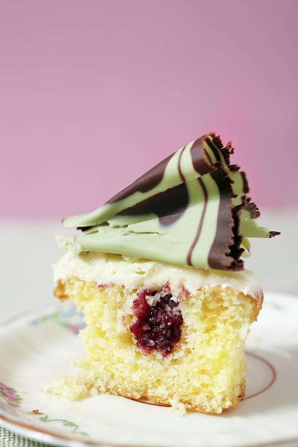 A Cupcake Filled With Jam And Topped With Mint Chocolate Curls Photograph by Lioba Schneider Fotodesign