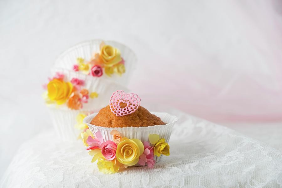 A Cupcake In A Paper Case Decorated With A Sugar Heart And Paper Flowers Photograph by Mandy Reschke