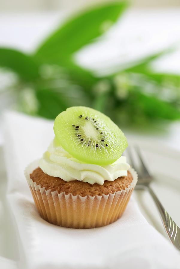 A Cupcake Topped With Cream And A Slice Of Kiwi Photograph by Ewa Rejmer
