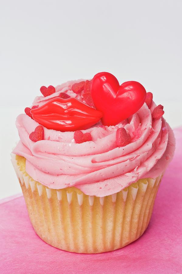 A Cupcake Topped With Pink Buttercream Icing, Red Lips And Hearts Photograph by Linda Burgess