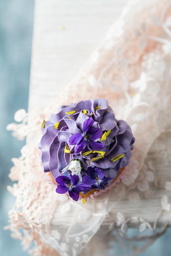 A Cupcake With Violets, Daisies, And Dandelion Petals Photograph by Mandy Reschke
