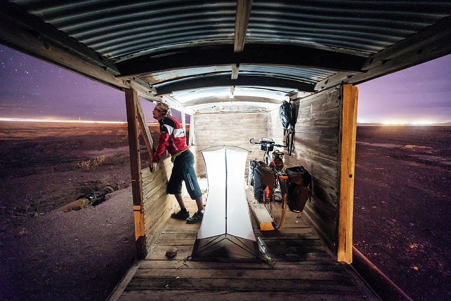 A cyclist in an abandoned railway wagon in Atacama Desert, Chile Photograph by Kamran Ali