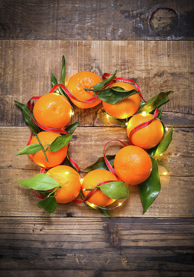 A Decorative Mandarin Garland With Fairy Lights And Ribbon Photograph by Stacy Grant
