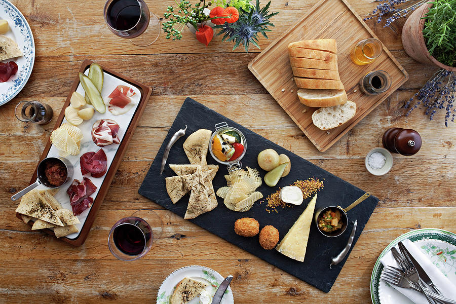 A Delightful Charcuterie Board And Cheese Board In The Middle Of A Table Photograph by Steven Joyce