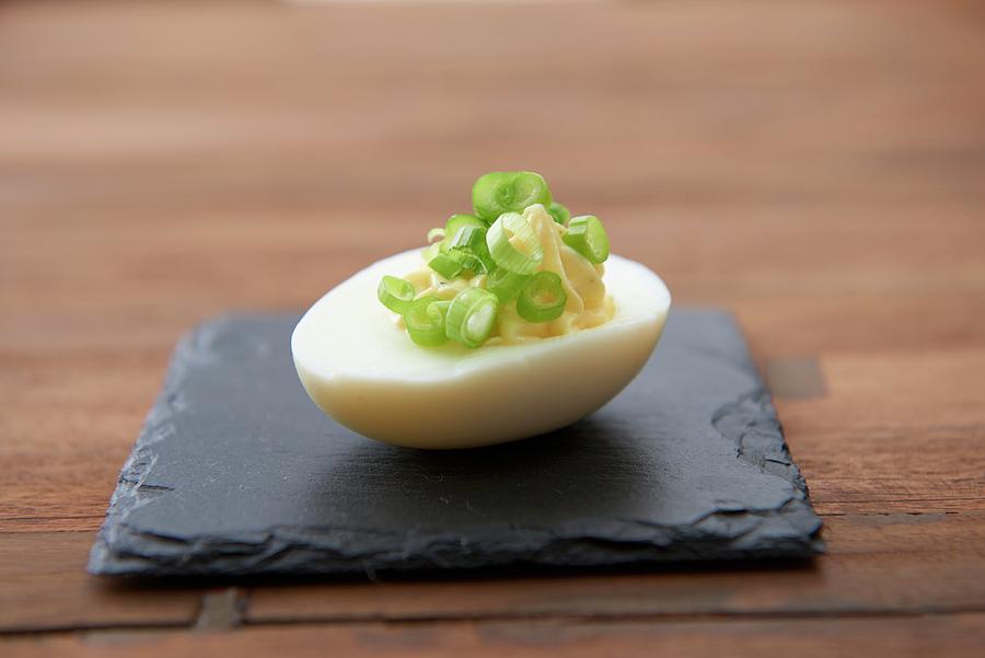 A Devilled Egg With Spring Onions Photograph by Jo Kirchherr