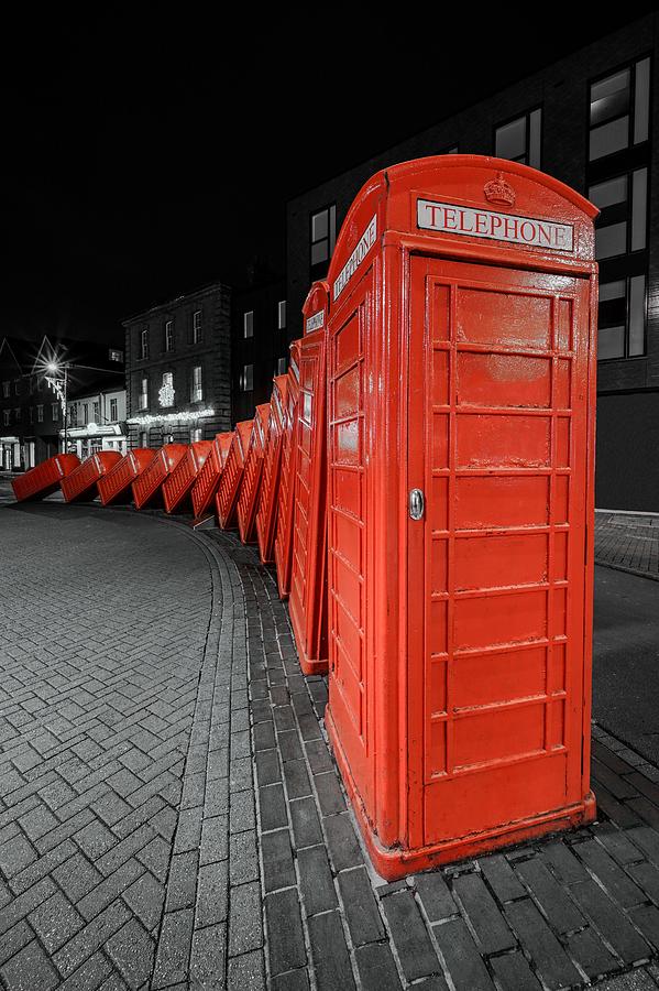 A Domino Effect With Red Phone Booths In London, England. Photograph