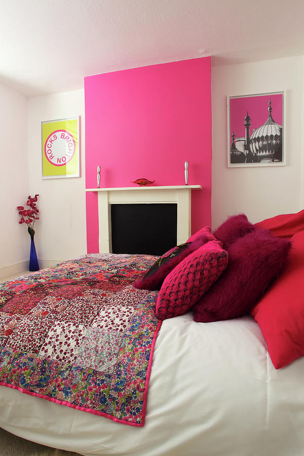 A Double Bed In A Bedroom With Pink And White Walls Photograph By ...