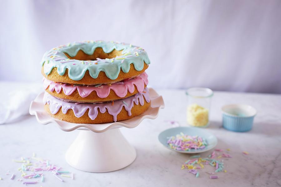 A Doughnut Cake With Three Pastel Coloured Glazes Photograph by The Kate Tin