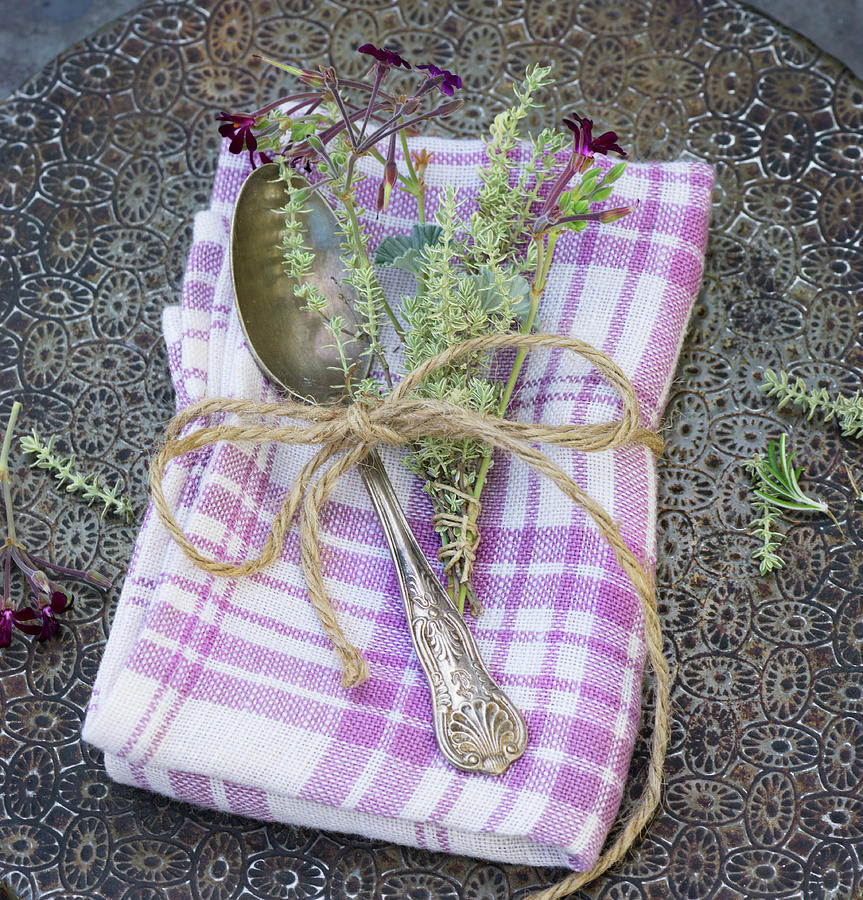 A Fabric Napkin With A Silver Spoon And A Sprig Of Thyme Photograph by Martina Schindler