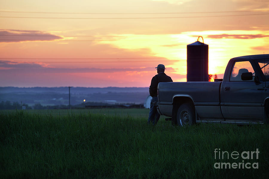 A Farmer On His Truck Watching A Sunset Photograph by Susanhsmith