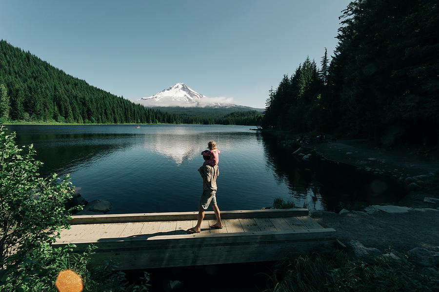 A Father Carries His Daughter On His Shoulders At Trillium Lake, Or ...