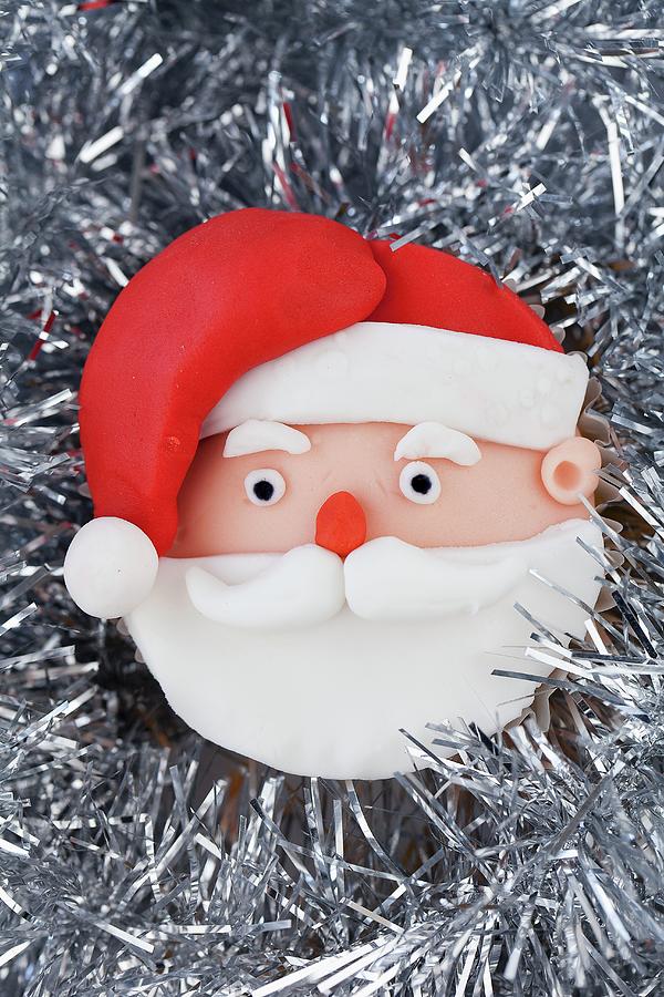 A Father Christmas Cupcake On Silver Tinsel Photograph by Zara Daly