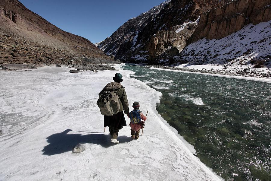A Father Leads His Son On Frozen Ice Photograph by Timothy Allen