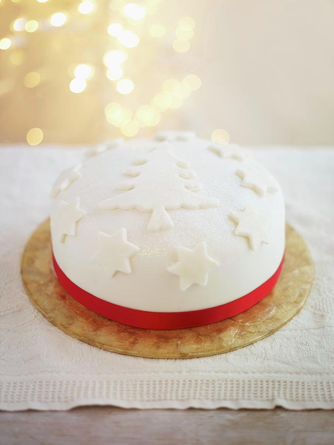 A Festive Christmas Cake Decorated With A Red Satin Ribbon Photograph by Myles New