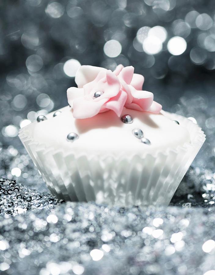 A Festive Cupcake Decorated With Silver Pearls And Sugar Flowers Photograph by Komar