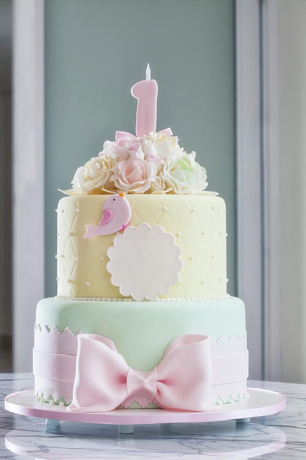 A Festively Decorated Birthday Cake In Delicate Pastel Tones Photograph by Karl Stanzel