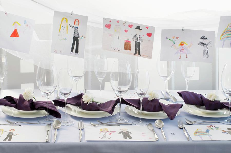 A Festively Laid Table With Childrens Drawings Hanging In The Background Photograph by Inge Ofenstein