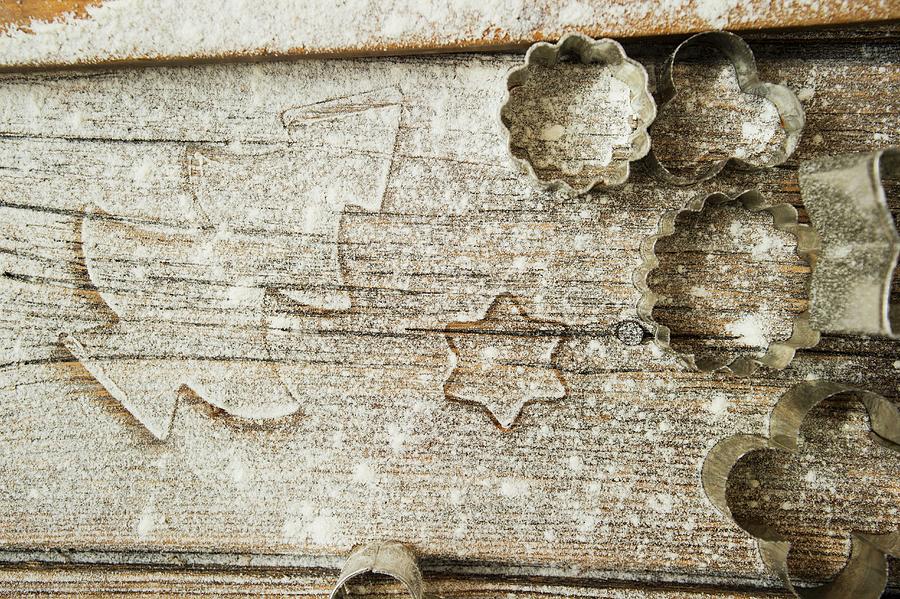A Floured Wooden Surface With Cookie Cutters Photograph by Rita Newman