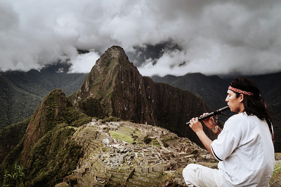A flutist at Macchu Picchu in Peruian Highlands Photograph by Kamran Ali