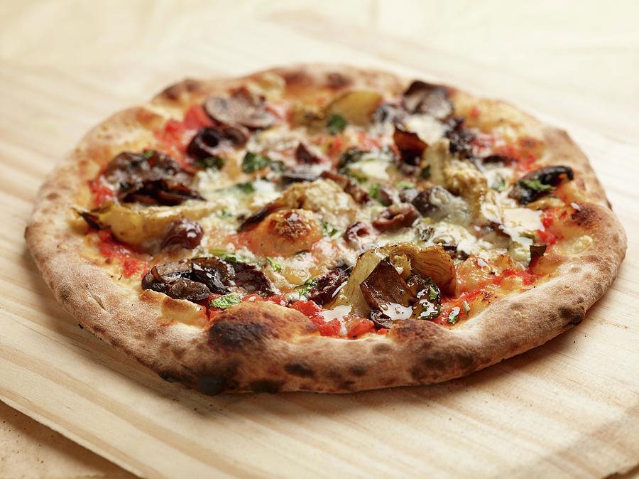 A Four Seasons Pizza Baked In A Wood-fired Oven Topped With Mushrooms, Artichokes And Olives Photograph by Rene Comet