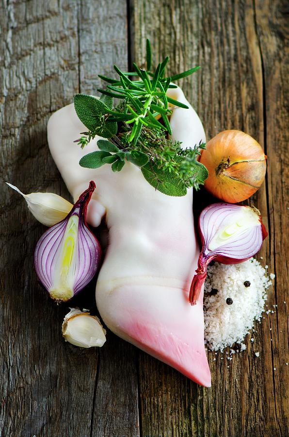 A Fresh Calfs Foot With Herbs, Soup Vegetables, Salt And Pepper On A Wooden Surface Photograph by Jamie Watson