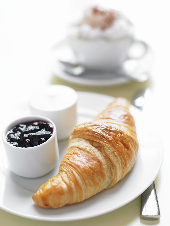 A Fresh Croissant With Blueberry Jam And Butter Photograph by Angela Francisca Endress