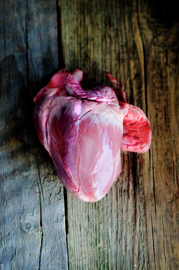 A Fresh Pigs Heart On A Wooden Board Photograph by Jamie Watson