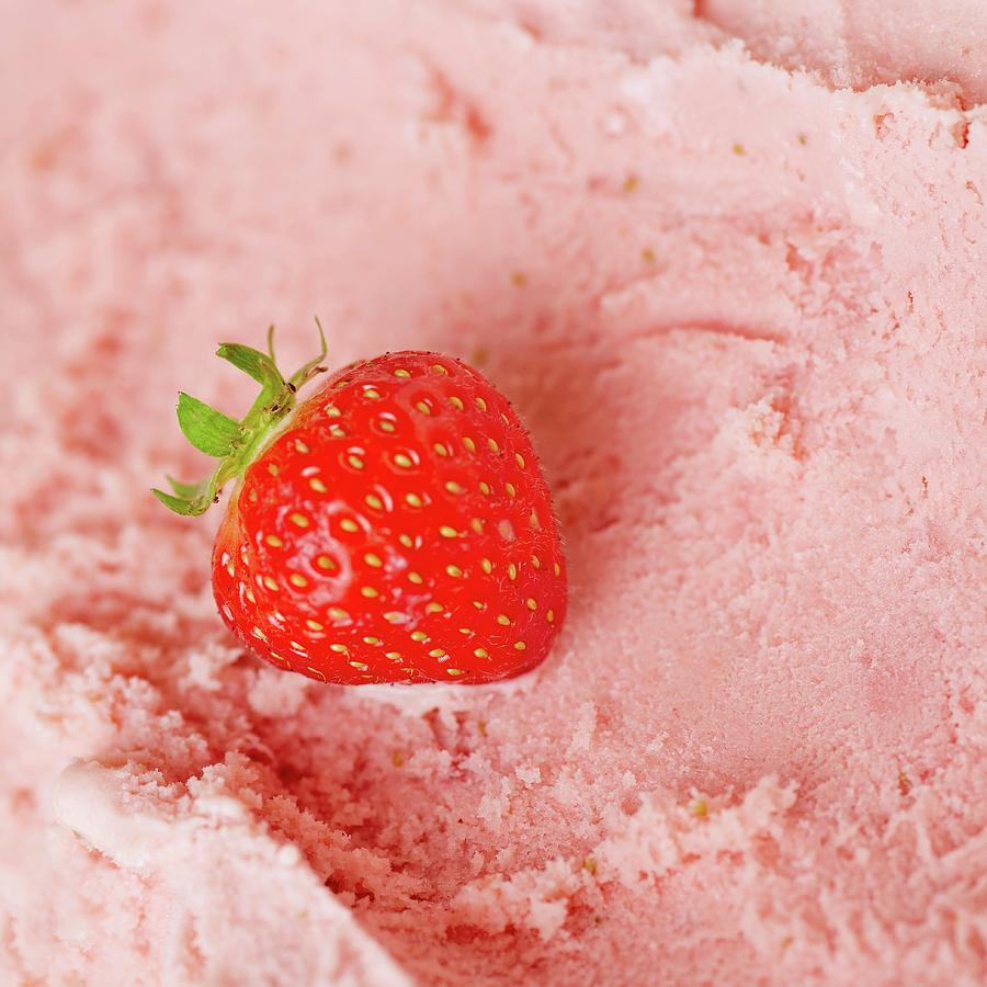 A Fresh Strawberry On Fresh Strawberry Ice Cream Ready To Be Scooped Photograph by Robert Kneschke