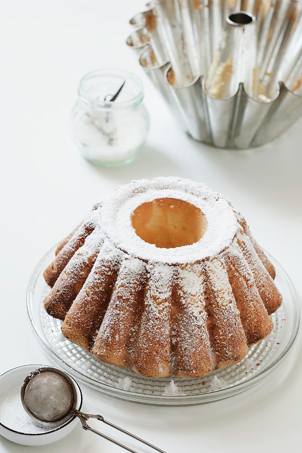 A Freshly Baked Bundt Cake Dusted With Icing Sugar Photograph by Edyta Girgiel