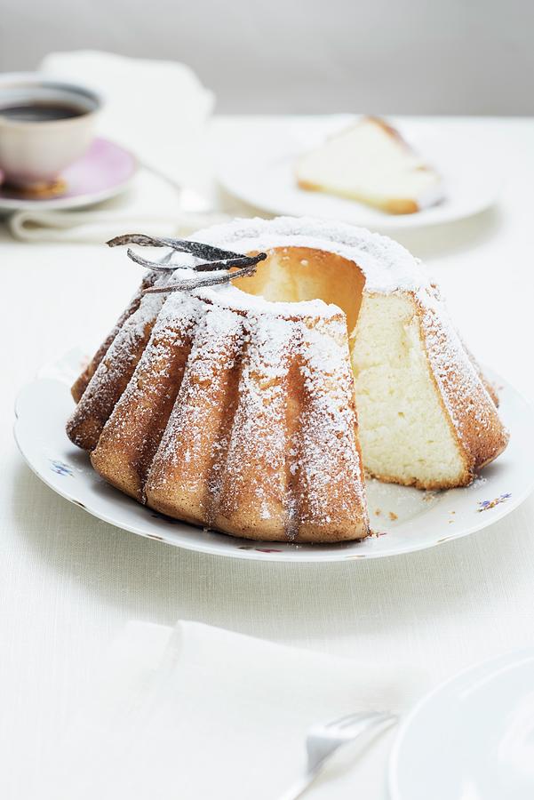 A Freshly Baked Bundt Cake With Icing Sugar And Vanilla Pods Photograph by Edyta Girgiel
