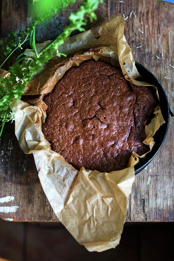 A Freshly Baked Chocolate Cake On Baking Paper In A Tin Photograph by Irina Meliukh