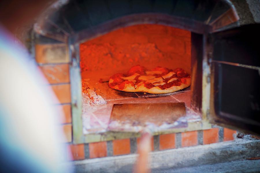 A Freshly Baked Pizza In A Wood-fired Oven Photograph by Kent Hwang Photography