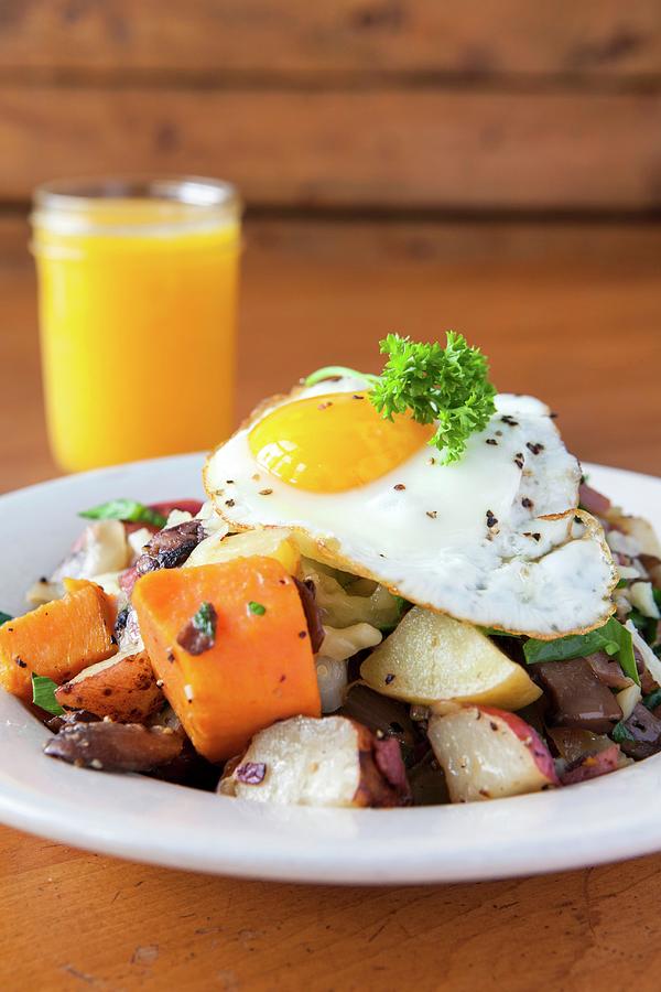 A Fried Egg On A Bed Of Fried Potatoes Mushrooms Turnips Served With Orange Juice usa Photograph by Amy Kalyn Sims