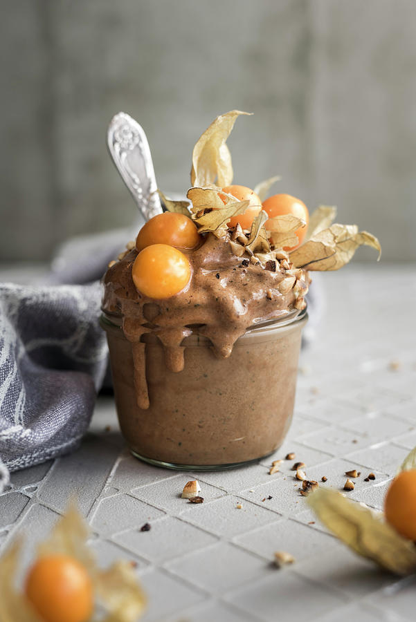 A Frozen Banana Smoothie With Cocoa, Physalis And Almonds Photograph by Healthylauracom