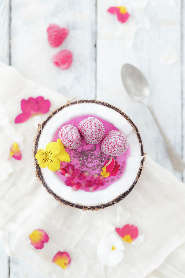 A Frozen Smoothie Bowl With Raspberries, Pomegranate Seeds And Edible Flowers Photograph by Jan Wischnewski