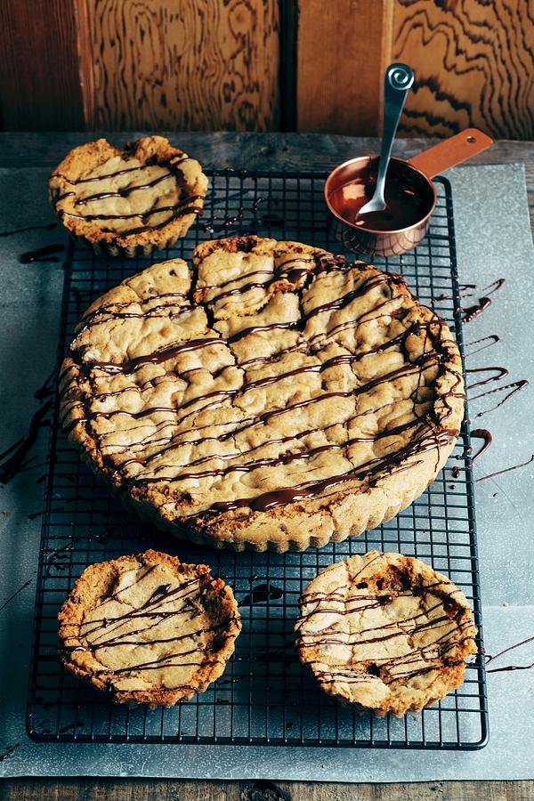 A Giant Chocolate Chunk Toffee Cookie With Smaller Ones Photograph by Adrian Britton
