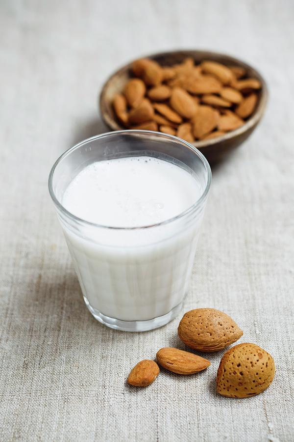 A Glass Of Almond Milk And A Bowl Of Almonds Photograph by Brigitte Sporrer