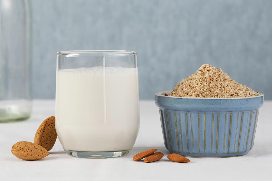 A Glass Of Almond Milk With Whole And Grated Almonds Photograph by Lydie Besancon