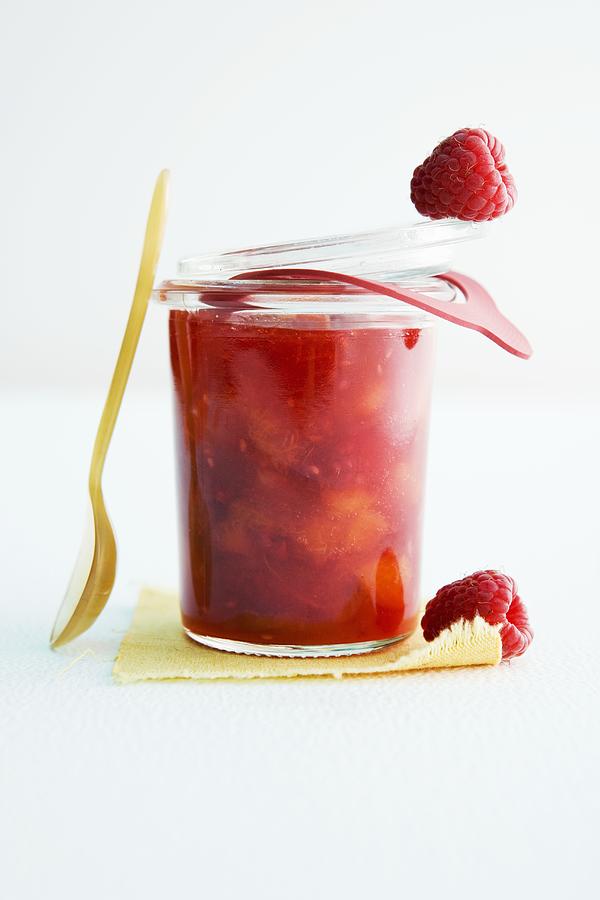 A Glass Of Apricot And Raspberry Jam Photograph by Michael Wissing