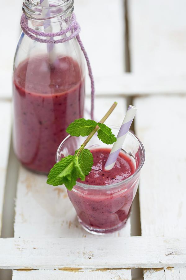 A Glass Of Berry Smoothie Garnished With Mint Photograph by Sandra Eckhardt
