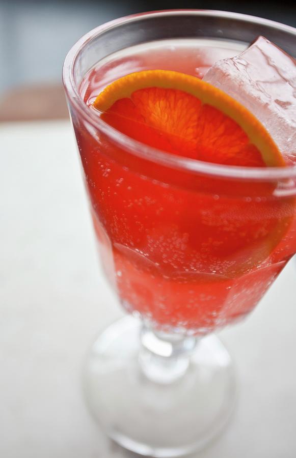 A Glass Of Blood Orange Soda With Citrus Slices And Ice Cubes Photograph by Ryla Campbell