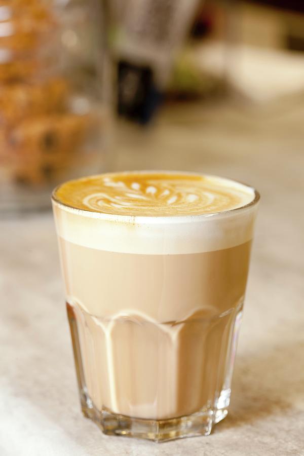 A Glass Of Caffe Latte With Milk Foam Photograph by Creative Photo Services