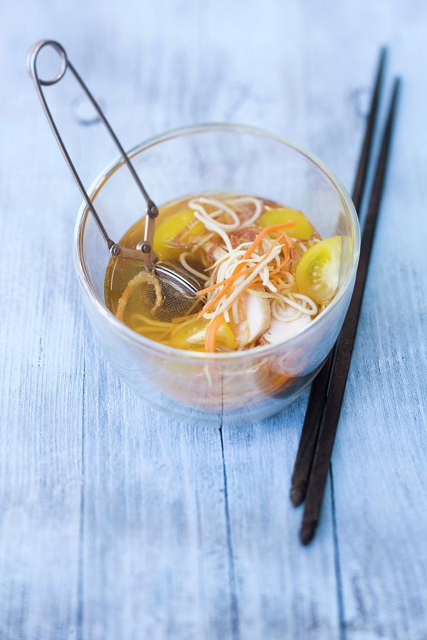 A Glass Of Chicken Noodle Soup With Galangal And Spices In A Tea Infuser Photograph by Michael Wissing