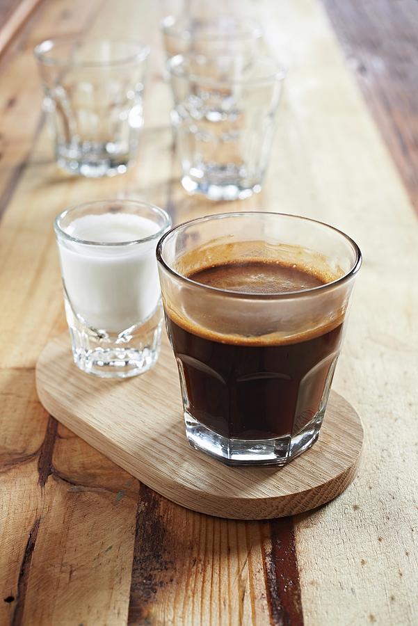 A Glass Of Coffee And A Shot Glass Of Milk Photograph by Great Stock!