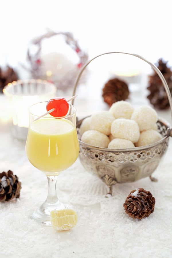 A Glass Of Eggnog, And White Egg Liqueur Chocolate Truffles In A Silver Bowl Photograph by Jane Saunders