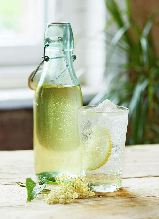 A Glass Of Elderflower Cordial And Sparkling Water In Front Of A Bottle Of Elderflower Cordial Photograph by Michael Hart