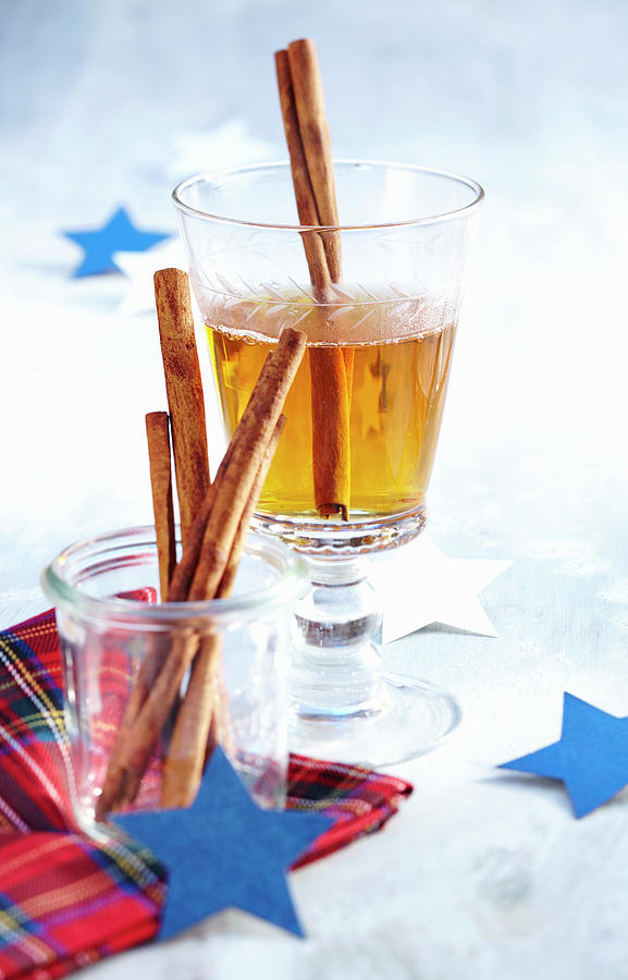 A Glass Of Hot Winter Whiskey With Cinnamon Sticks, Almonds And Apple Juice For Christmas Photograph by Teubner Foodfoto