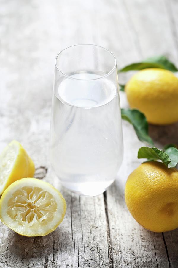 A Glass Of Lemon Water And Fresh Lemons Photograph by Malgorzata Stepien