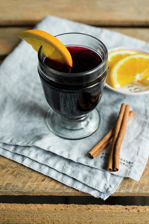 A Glass Of Mulled Wine With A Slice Of Orange Photograph by Sarka Babicka